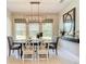 Bright dining room with large windows, a modern chandelier, and stylish decor at 584 Aldenham Ln, Ormond Beach, FL 32174