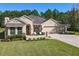 Charming single-story home with well-manicured lawn, front porch, and a two-car garage at 584 Aldenham Ln, Ormond Beach, FL 32174