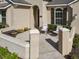Inviting front porch with seating area, featuring detailed architectural accents and landscape at 584 Aldenham Ln, Ormond Beach, FL 32174
