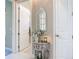 Hallway with white doors, and decorated side table at 584 Aldenham Ln, Ormond Beach, FL 32174