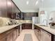 Modern kitchen featuring stainless steel appliances, sleek countertops, and dark wood cabinets at 584 Aldenham Ln, Ormond Beach, FL 32174