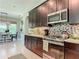 Elegant kitchen features stainless steel appliances, tile backsplash, and dark cabinetry at 584 Aldenham Ln, Ormond Beach, FL 32174