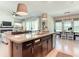 Open-concept kitchen with island, stainless appliances, and views into the living and dining areas at 584 Aldenham Ln, Ormond Beach, FL 32174