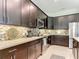 Gourmet kitchen with stainless steel appliances, dark cabinetry, and under-cabinet lighting at 584 Aldenham Ln, Ormond Beach, FL 32174