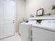 Well-organized laundry room with modern washer and dryer, and ample storage space at 584 Aldenham Ln, Ormond Beach, FL 32174