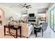 Inviting living room featuring a modern fireplace, ceiling fan, and stylish decor at 584 Aldenham Ln, Ormond Beach, FL 32174