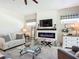 Comfortable living room with a modern fireplace, TV, and stylish decor at 584 Aldenham Ln, Ormond Beach, FL 32174