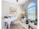 Bright office space with large windows, featuring a white desk, rug, and comfortable seating at 584 Aldenham Ln, Ormond Beach, FL 32174