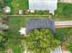 Aerial view of the property highlighting the roof, backyard with patio, landscaping, and privacy fence at 748 Neuse Ave, Orlando, FL 32804