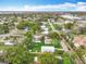 Wide aerial view of a suburban home near a waterfront, surrounded by mature trees and lush landscapes at 748 Neuse Ave, Orlando, FL 32804