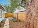 Spacious backyard with a new wood fence, stone walkway, lush landscaping, and a large tree at 748 Neuse Ave, Orlando, FL 32804