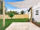 A nicely landscaped backyard with a shade sail and tropical plants at 748 Neuse Ave, Orlando, FL 32804