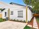 Inviting backyard featuring a paved patio, a shade sail, fresh landscaping, and privacy fence at 748 Neuse Ave, Orlando, FL 32804