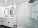 This luxurious bathroom features a walk-in shower, modern fixtures, and a double vanity with stylish lighting at 748 Neuse Ave, Orlando, FL 32804