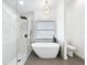 Modern bathroom featuring a sleek bathtub and glass-enclosed shower with rain showerhead, creating a spa-like experience at 748 Neuse Ave, Orlando, FL 32804