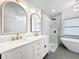 Elegant bathroom featuring double vanity, gold accents, walk-in glass shower, and modern fixtures at 748 Neuse Ave, Orlando, FL 32804