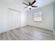 Bright bedroom features wood look floors, a ceiling fan, a large closet and a window at 748 Neuse Ave, Orlando, FL 32804