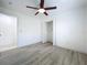 A large bedroom with wood-look floors has plenty of natural light and closet space at 748 Neuse Ave, Orlando, FL 32804