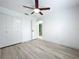 Bedroom features wood-look floors, closet and doorway to the adjacent room in the house at 748 Neuse Ave, Orlando, FL 32804