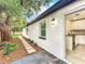 Exterior view of the home with a door leading into the kitchen and landscaped walkway at 748 Neuse Ave, Orlando, FL 32804