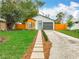 Charming home featuring a well-manicured lawn, inviting walkway, and an attached one car garage at 748 Neuse Ave, Orlando, FL 32804