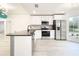 Bright open concept kitchen featuring stainless steel appliances, granite countertops, and bay window at 748 Neuse Ave, Orlando, FL 32804
