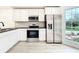 Bright kitchen featuring stainless steel appliances and white cabinets at 748 Neuse Ave, Orlando, FL 32804