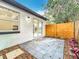 Cozy outdoor patio area with modern pavers, wood fence, and sliding glass door access to the home at 748 Neuse Ave, Orlando, FL 32804