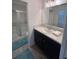 Modern bathroom features a white vanity with a large mirror and walk-in shower with sliding glass doors at 3575 Cochran St, The Villages, FL 32163