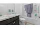 Bathroom featuring a tub and shower combination with patterned curtain, dark vanity and a light flooring at 3575 Cochran St, The Villages, FL 32163