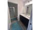 Modern bathroom features a white vanity with a large mirror and walk-in shower with sliding glass doors at 3575 Cochran St, The Villages, FL 32163