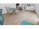 Open-concept dining room featuring a stylish glass table, and access to the living room at 3575 Cochran St, The Villages, FL 32163