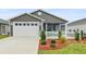 Charming single-story home featuring a two-car garage and well-manicured front yard at 3575 Cochran St, The Villages, FL 32163