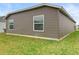 Back exterior of home featuring neutral siding, and green lawn at 3575 Cochran St, The Villages, FL 32163