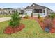 Street view of a well-maintained home with vibrant landscaping and a white picket fence at 3575 Cochran St, The Villages, FL 32163