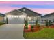 Charming single-story home with attached two-car garage, and a well-manicured front lawn at 3575 Cochran St, The Villages, FL 32163