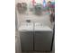 Laundry room features a washer, dryer, and storage shelves at 3575 Cochran St, The Villages, FL 32163