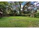 Expansive backyard with mature trees, providing shade and privacy at 608 Grand St, Orlando, FL 32805