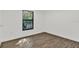 Bedroom featuring wood floors, a large window, and neutral decor at 608 Grand St, Orlando, FL 32805