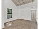 Bright bedroom with wood floors, modern window and ensuite bathroom with natural light at 608 Grand St, Orlando, FL 32805