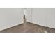 Empty bedroom featuring hardwood floors, white walls, and neutral trim at 608 Grand St, Orlando, FL 32805