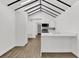 Open-concept kitchen with white cabinetry, modern appliances, and a view into the living area at 608 Grand St, Orlando, FL 32805