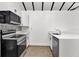 A well-equipped kitchen showcasing stainless steel appliances, and sleek white countertops at 608 Grand St, Orlando, FL 32805