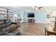 Bright living room with blue accent wall, wood-look flooring, and ceiling fan at 63 Benjamin Dr, Ormond Beach, FL 32176