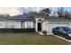Charming single-story home with solar panels, a well-manicured lawn, and a two-car garage at 1136 Doncaster Ct, Kissimmee, FL 34758