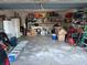 Spacious garage with lots of storage opportunities, shelving, and concrete flooring at 1136 Doncaster Ct, Kissimmee, FL 34758