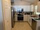 Efficient kitchen with stainless steel appliances, white cabinets, and tile backsplash at 1136 Doncaster Ct, Kissimmee, FL 34758