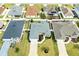 Aerial view of a home with lush landscaping, pristine lawn, and neutral gray roof at 3381 Harris Ct, The Villages, FL 32163
