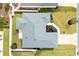 Aerial view of a well-maintained gray roof, a patio, and an enclosed lanai at 3381 Harris Ct, The Villages, FL 32163