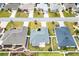 Aerial view of a home with lush landscaping, pristine lawn, and neutral gray roof at 3381 Harris Ct, The Villages, FL 32163